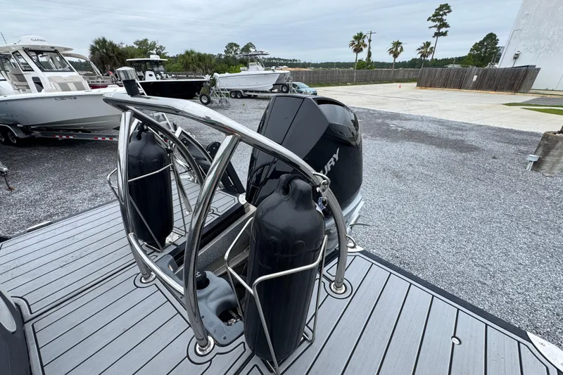 Slide: The Image of 2023 Barletta CORSA 25UC boat with Mercury engine, docked in a marina. - 31