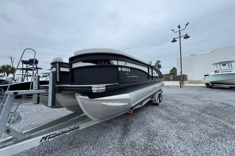 Slide: The Image of 2023 Barletta CORSA 25UC pontoon boat on trailer in parking lot. - 4