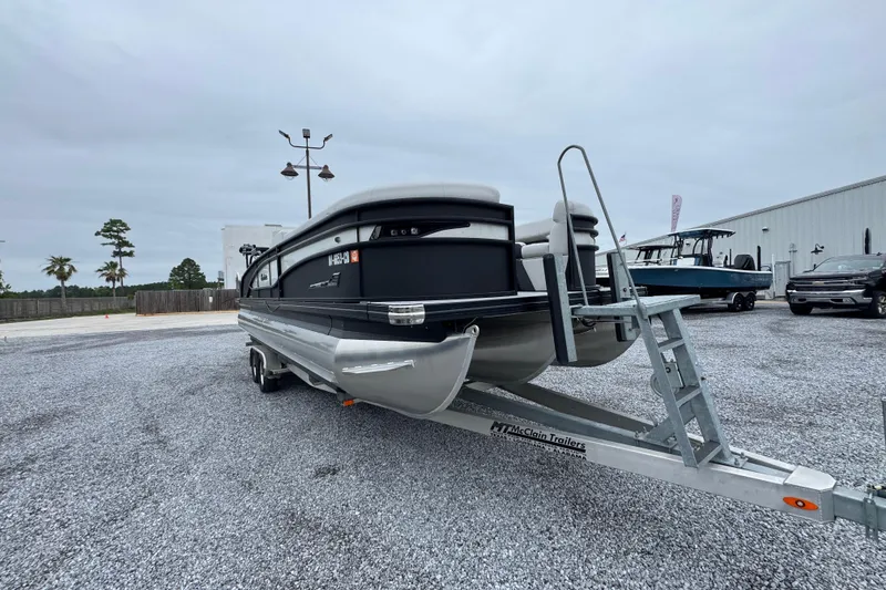 Slide: The Image of 2023 Barletta CORSA 25UC pontoon boat on trailer in parking lot. - 6