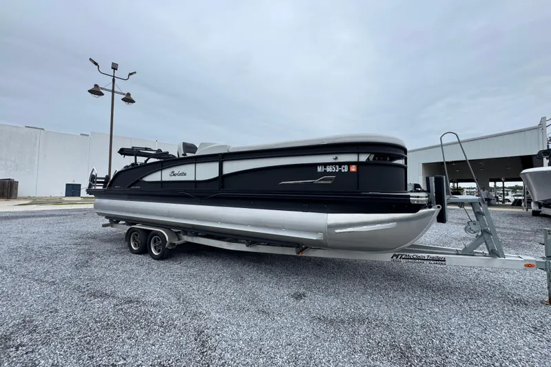 Slide: The Image of 2023 Barletta CORSA 25UC pontoon boat on trailer in outdoor setting. - 7