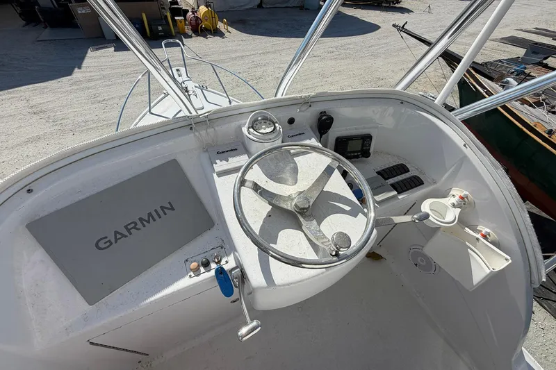 Slide: The Image of 1977 Bertram 31 Flybridge Cruiser helm with Garmin navigation system and steering wheel. - 15