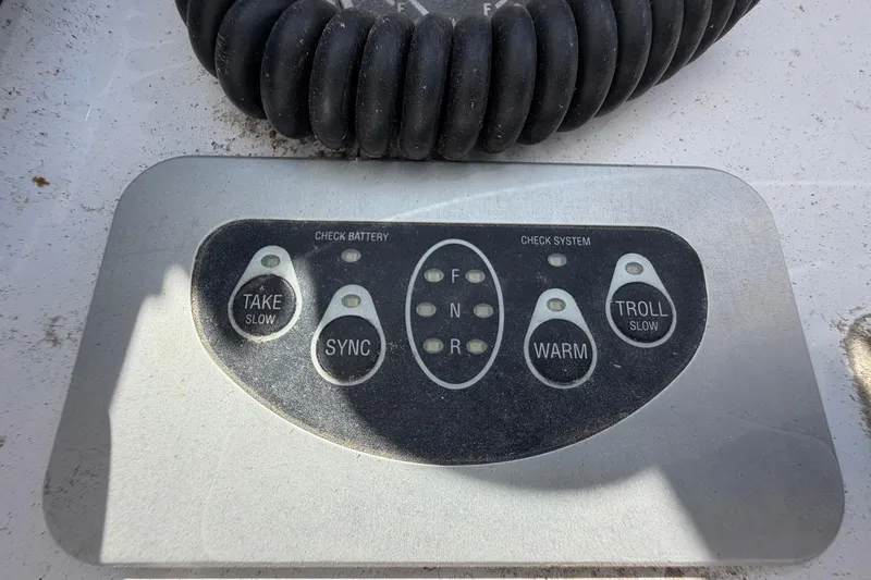 Slide: The Image of Control panel of a 1977 Bertram 31 Flybridge Cruiser with various function buttons. - 20