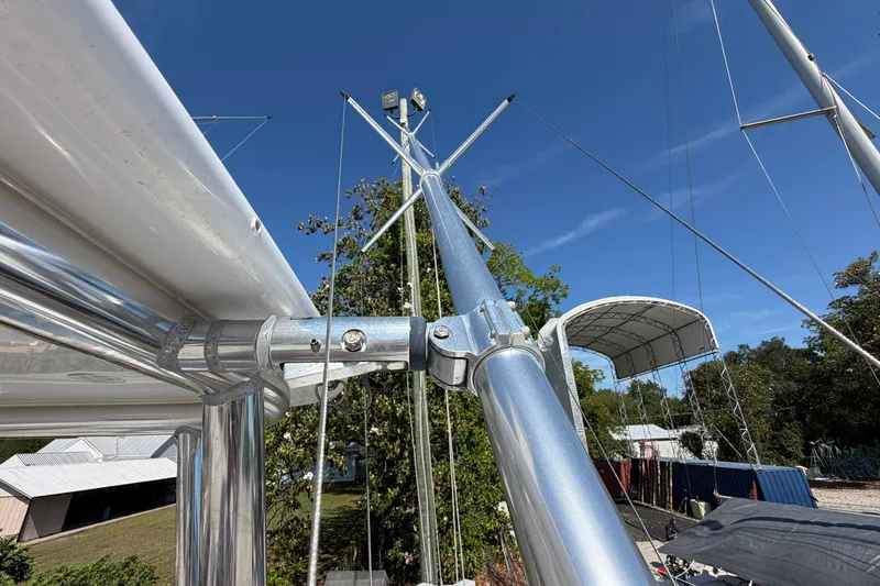 Slide: The Image of 1977 Bertram 31 Flybridge Cruiser mast and rigging under clear blue sky. - 23