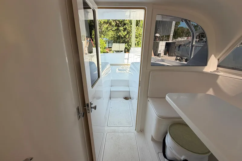 Slide: The Image of 1977 Bertram 31 Flybridge Cruiser interior with seating and outdoor view. - 24