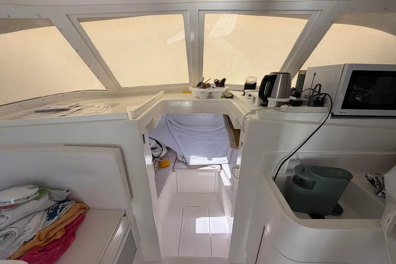 Slide: The Image of Interior of a 1977 Bertram 31 Flybridge Cruiser with kitchen appliances and storage. - 26