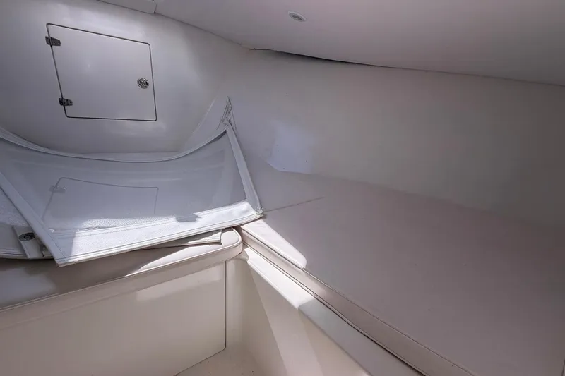 Slide: The Image of Interior cabin of a 1977 Bertram 31 Flybridge Cruiser, featuring storage compartment and seating area. - 29