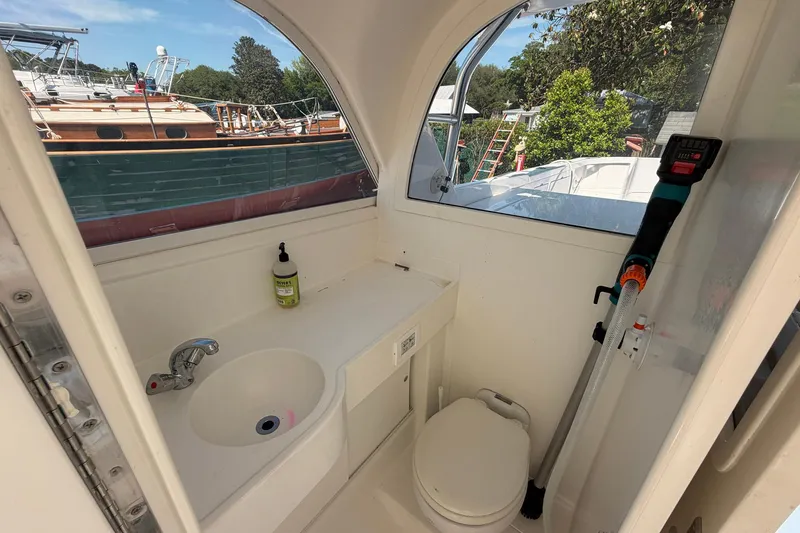 Slide: The Image of Interior of 1977 Bertram 31 Flybridge Cruiser with sink and toilet. - 33