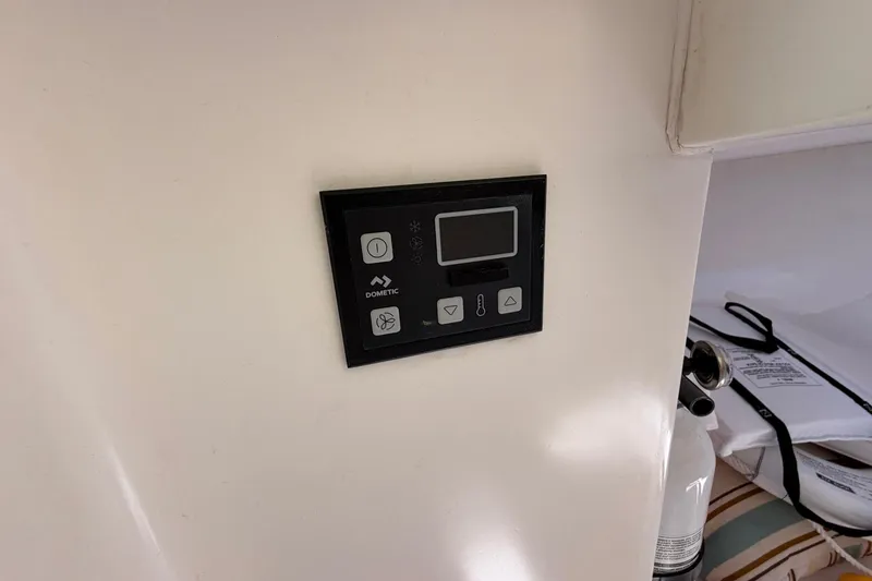 Slide: The Image of Control panel inside a 1977 Bertram 31 Flybridge Cruiser boat cabin. - 34