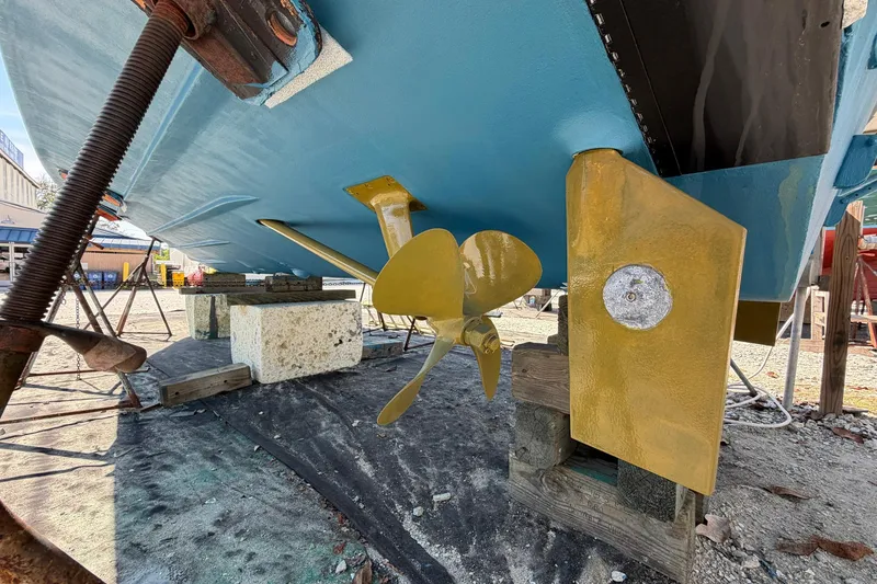 Slide: The Image of 1977 Bertram 31 Flybridge Cruiser's propeller and rudder, dry docked for maintenance. - 36