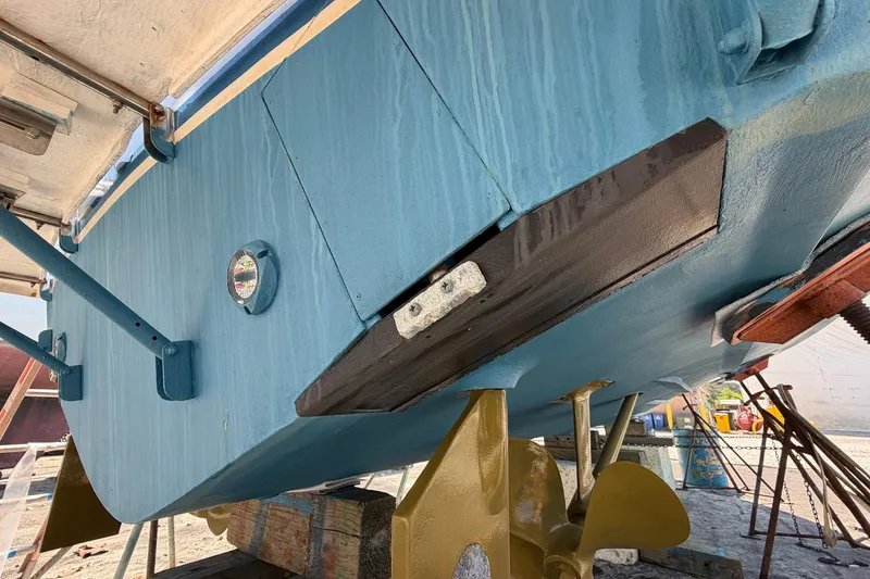 Slide: The Image of 1977 Bertram 31 Flybridge Cruiser underside with blue hull and gold propeller. - 37