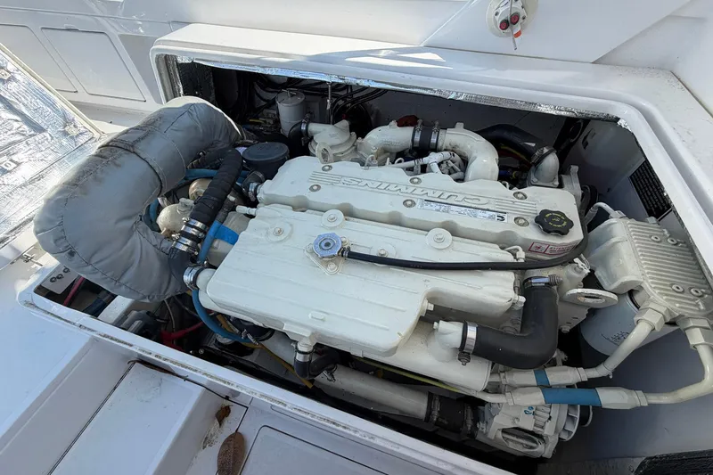 Slide: The Image of Engine compartment of a 1977 Bertram 31 Flybridge Cruiser, showcasing a Cummins marine engine. - 39