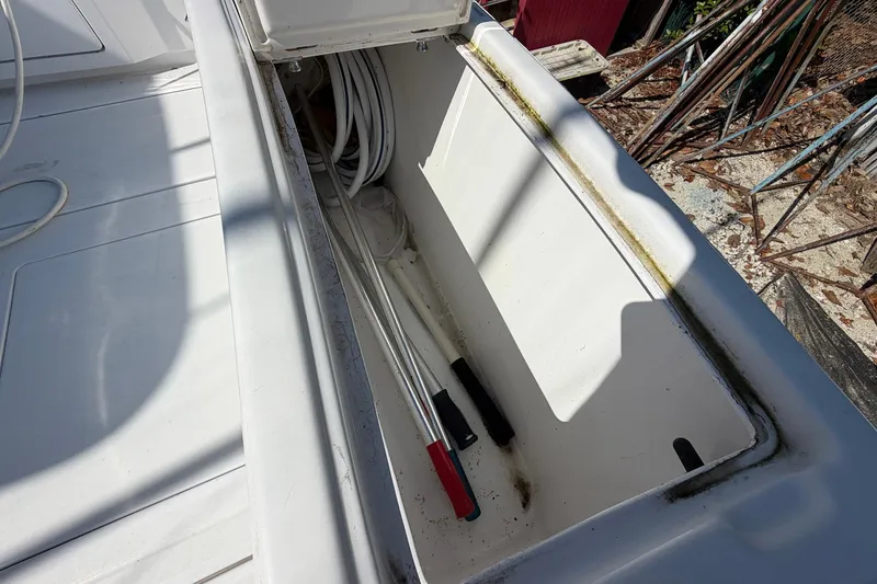 Slide: The Image of Storage compartment on a 1977 Bertram 31 Flybridge Cruiser, containing ropes and tools. - 40