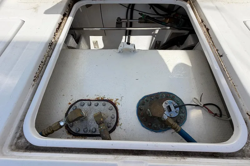 Slide: The Image of Fuel tank compartment of a 1977 Bertram 31 Flybridge Cruiser, showing connections and fittings. - 41