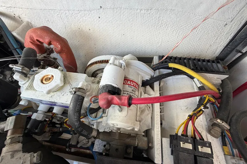 Slide: The Image of Engine compartment of a 1977 Bertram 31 Flybridge Cruiser with visible wiring and components. - 42