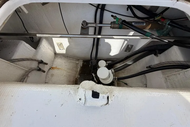 Slide: The Image of 1977 Bertram 31 Flybridge Cruiser engine compartment with hydraulic steering components. - 44