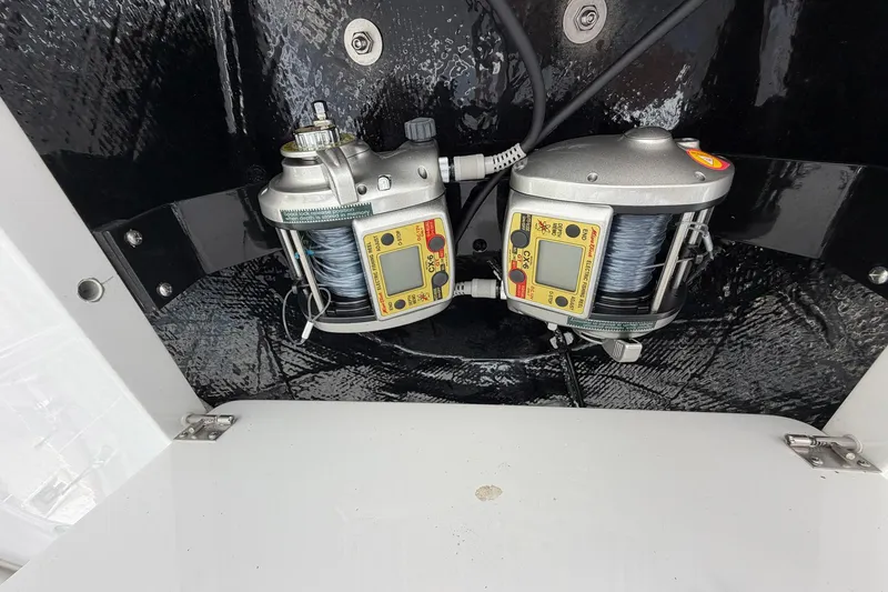 Slide: The Image of Dual electric fishing reels on a 1977 Bertram 31 Flybridge Cruiser. - 45