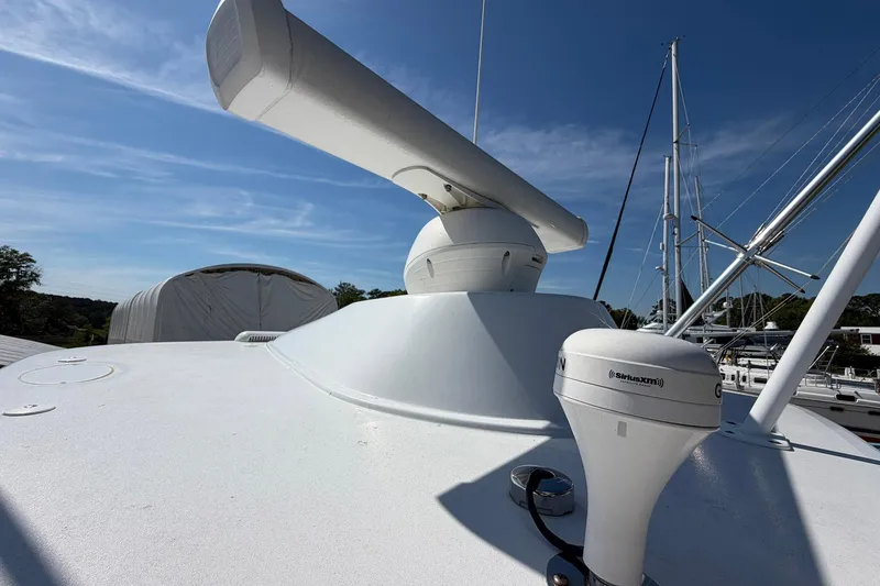 Slide: The Image of 1977 Bertram 31 Flybridge Cruiser radar and antenna setup under clear blue sky. - 46