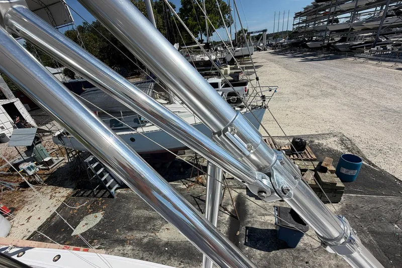 Slide: The Image of 1977 Bertram 31 Flybridge Cruiser in boatyard, showcasing polished metal structures. - 47