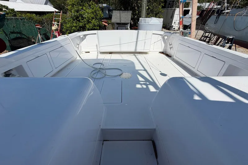 Slide: The Image of 1977 Bertram 31 Flybridge Cruiser deck, spacious and clean, with white finish. - 8