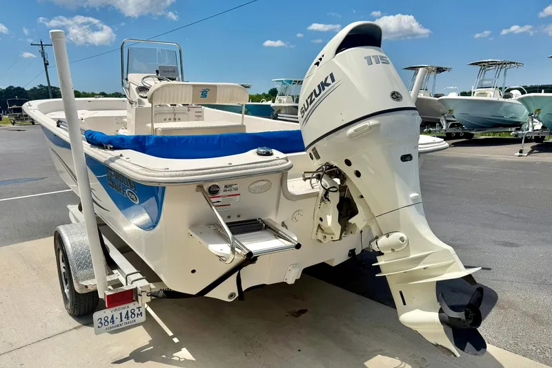 Slide: The Image of 2019 Carolina Skiff 198 DLV boat with Suzuki 115 outboard motor on trailer. - 10