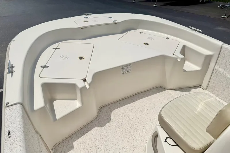 Slide: The Image of 2019 Carolina Skiff 198 DLV boat interior with storage compartments and seating. - 11