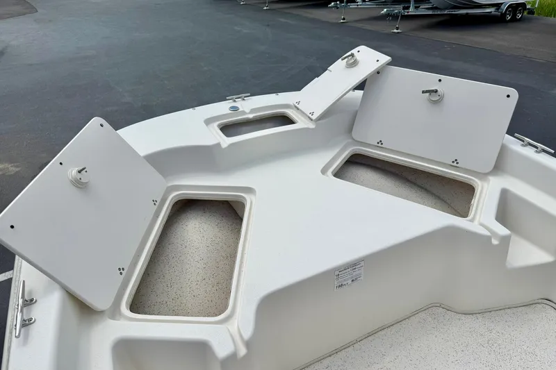Slide: The Image of 2019 Carolina Skiff 198 DLV boat storage compartments open on deck. - 12