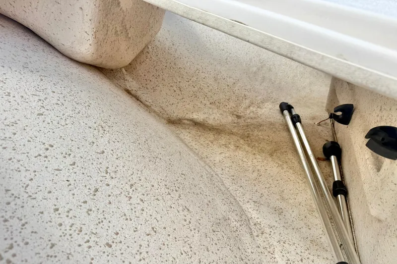 Slide: The Image of Interior view of a 2019 Carolina Skiff 198 DLV boat, showing textured surfaces and metal supports. - 13