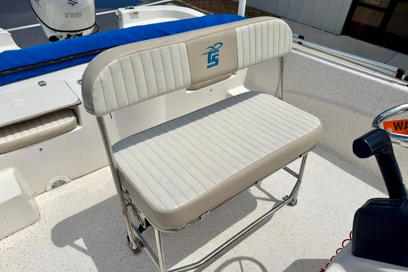 Slide: The Image of 2019 Carolina Skiff 198 DLV boat seat with logo, white upholstery, and stainless steel frame. - 20