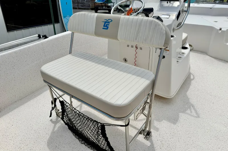Slide: The Image of 2019 Carolina Skiff 198 DLV boat interior with white seating and steering console. - 21