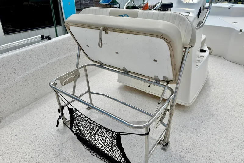 Slide: The Image of 2019 Carolina Skiff 198 DLV boat interior with foldable seat and storage net. - 22