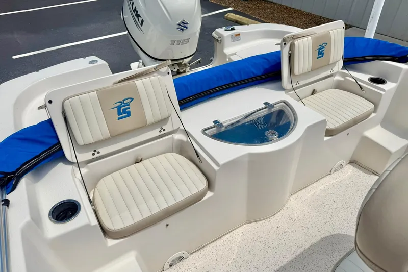 Slide: The Image of 2019 Carolina Skiff 198 DLV boat interior with seating and Suzuki 115 engine. - 24