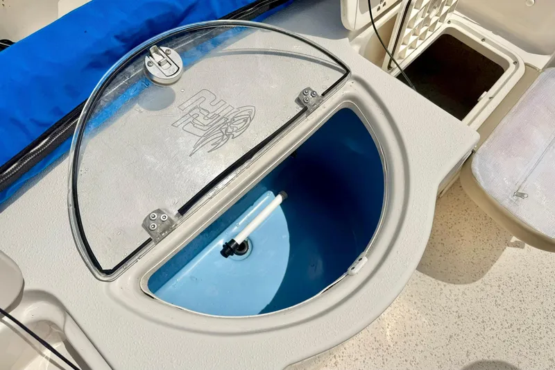 Slide: The Image of Livewell compartment on a 2019 Carolina Skiff 198 DLV boat, featuring a clear lid. - 27