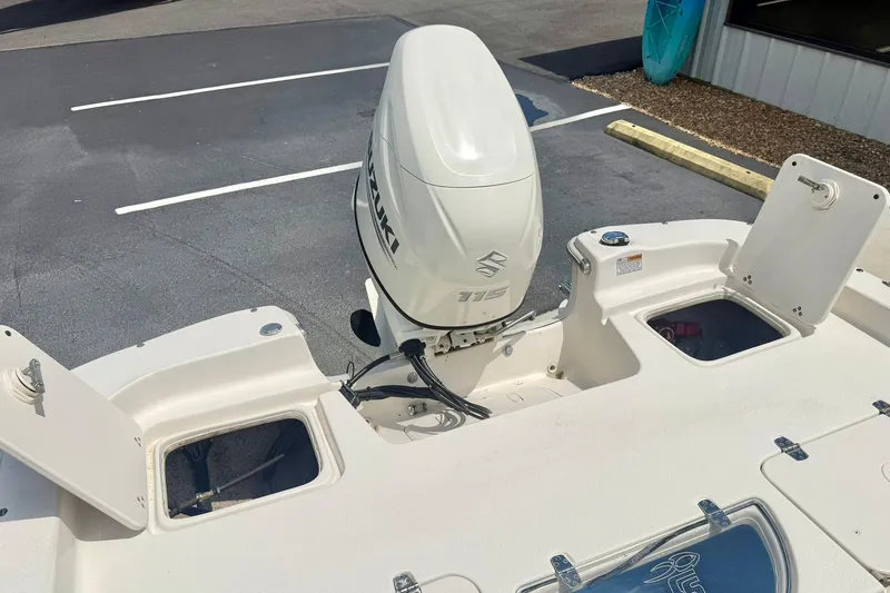 Slide: The Image of 2019 Carolina Skiff 198 DLV boat with Suzuki 115 outboard motor in parking lot. - 28