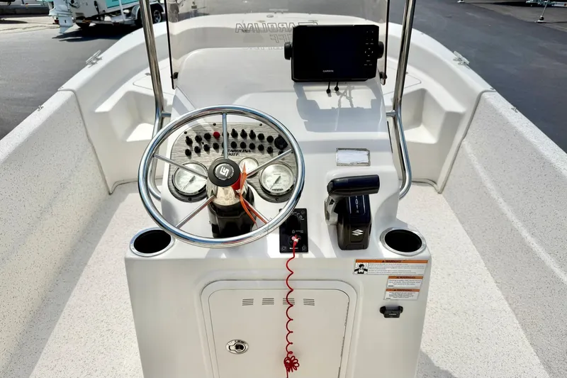 Slide: The Image of 2019 Carolina Skiff 198 DLV boat console with steering wheel and controls. - 3