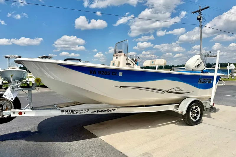 Slide: The Image of 2019 Carolina Skiff 198 DLV boat on trailer under blue sky. - 5
