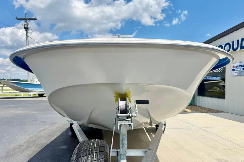 Slide: The Image of 2019 Carolina Skiff 198 DLV boat on trailer, under clear blue sky. - 8