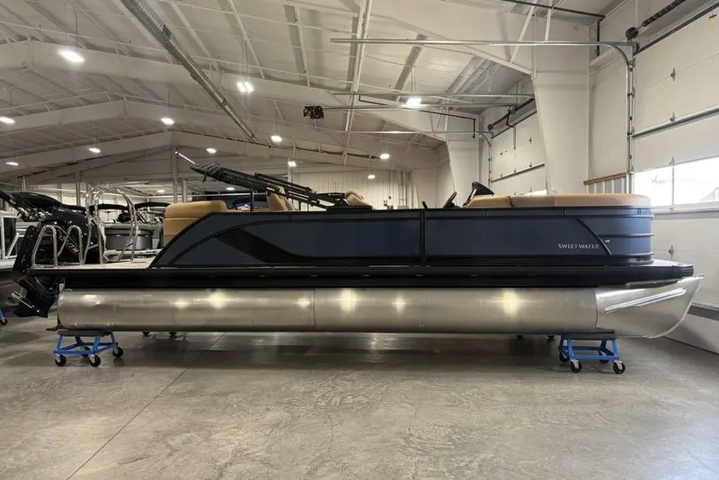 The Image of 2026 Godfrey Sweetwater 2286 QS pontoon boat in a spacious indoor showroom. - 0