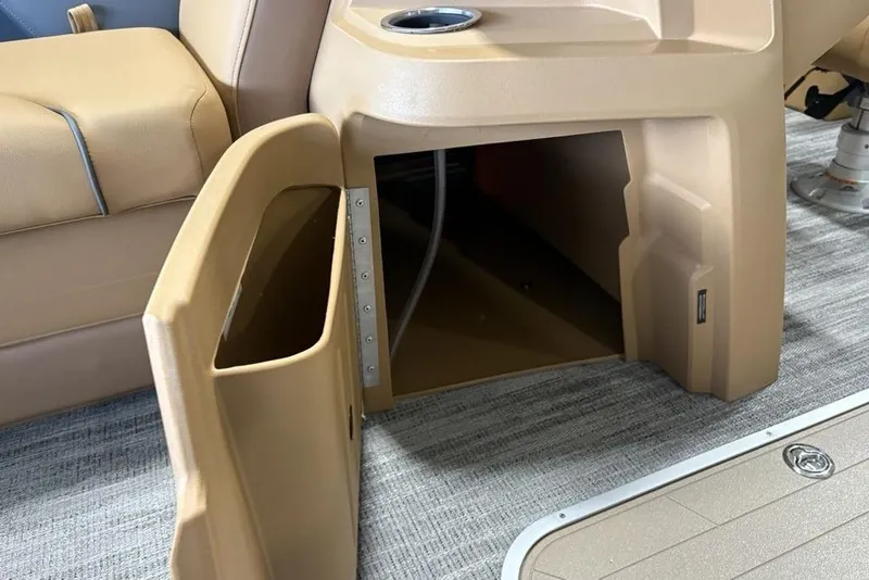 Slide: The Image of Open storage compartment on 2026 Godfrey Sweetwater 2286 QS boat, featuring beige interior. - 15