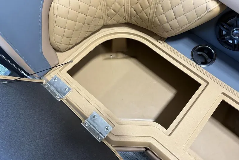 Slide: The Image of 2026 Godfrey Sweetwater 2286 QS boat storage compartment with quilted seating and cup holder. - 3