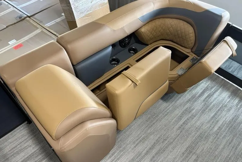 Slide: The Image of Luxurious seating on 2026 Godfrey Sweetwater 2286 QS pontoon boat, featuring tan upholstery and storage. - 7