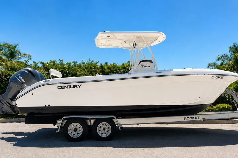 The Image of 2022 Century 2600 Center Console boat on trailer, side view, clear sky background. - 0