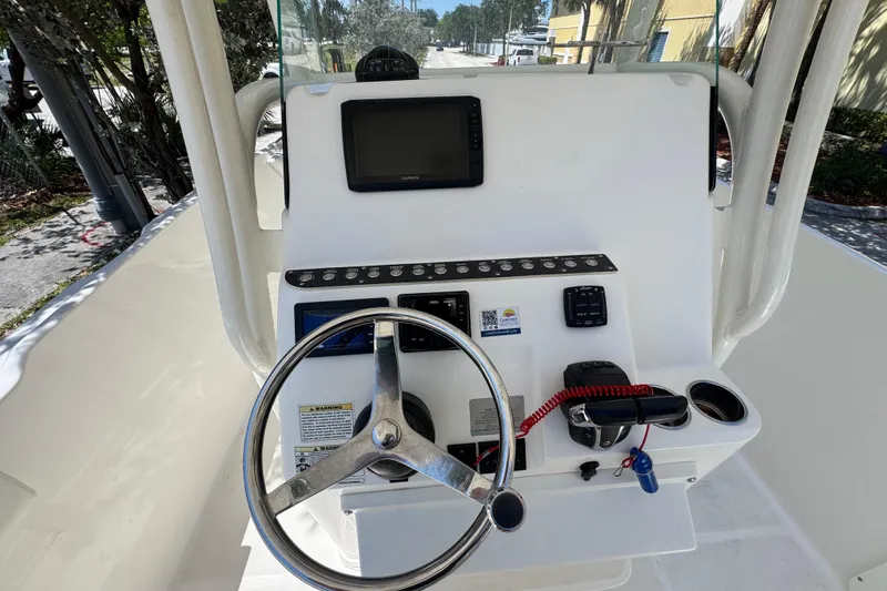 Slide: The Image of 2022 Century 2600 Center Console boat dashboard with steering wheel and navigation display. - 10