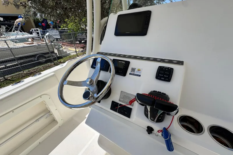 Slide: The Image of Steering console of a 2022 Century 2600 Center Console boat with navigation equipment. - 11
