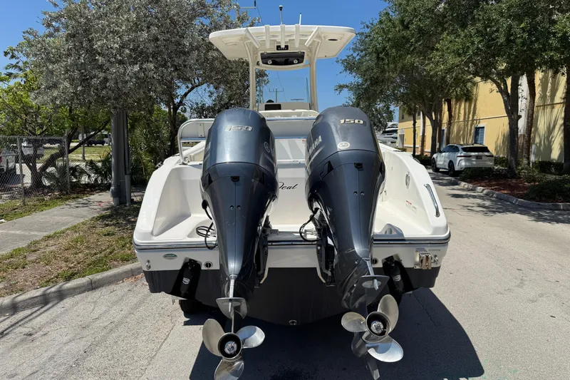 Slide: The Image of 2022 Century 2600 Center Console boat with dual Yamaha 150 engines, parked outdoors. - 4