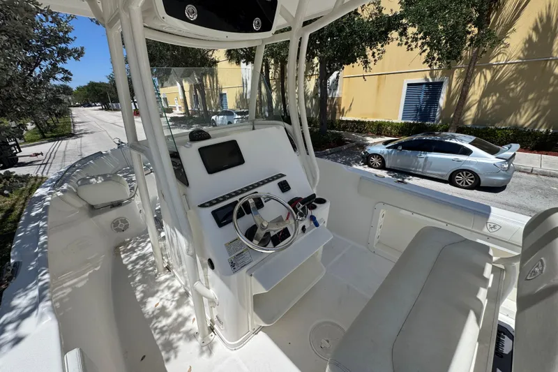 Slide: The Image of 2022 Century 2600 Center Console boat interior with steering wheel and seating. - 9