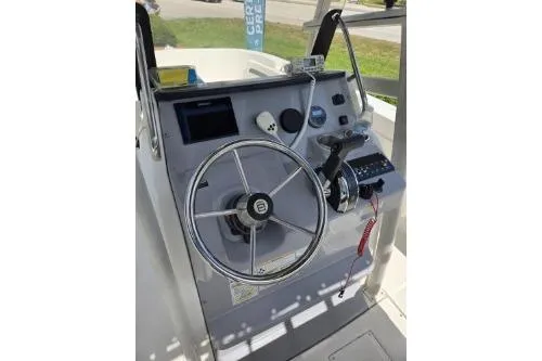 Slide: The Image of 2023 Trophy T22 boat console with steering wheel and control panel. - 10