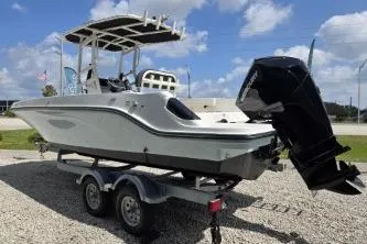 Slide: The Image of 2023 Trophy T22 boat on trailer under blue sky. - 3