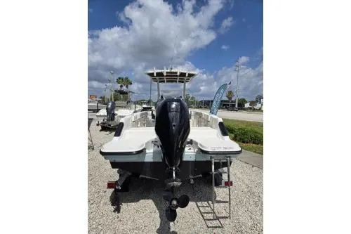 Slide: The Image of 2023 Trophy T22 boat with outboard motor, parked on gravel under a partly cloudy sky. - 5