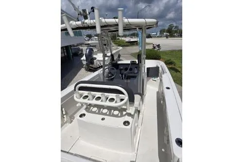 Slide: The Image of 2023 Trophy T22 boat interior with rod holders and console, parked outdoors. - 7