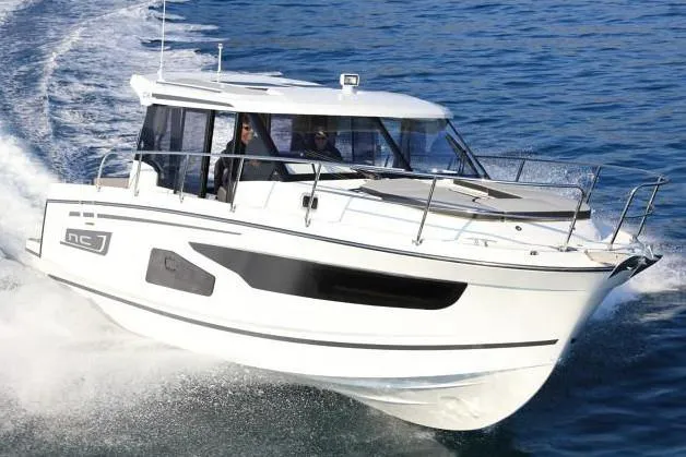 Slide: The Image of Jeanneau NC 1095 2022 cruising on open water, modern motorboat. - 6